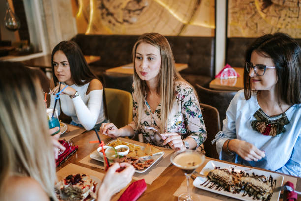 istock Female friends eating at restaurant 1190561925