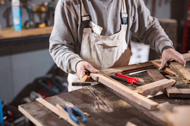 istock Carpenter working on a old wood in a retro vintage workshop. 1190563259