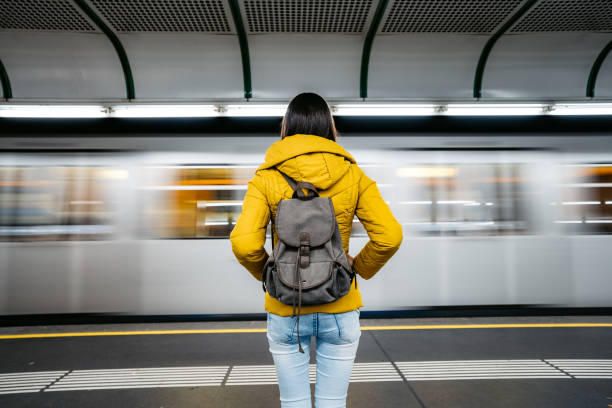 Waiting subway train Young Caucasian woman with backpack waiting for a subway train. subway platform photos stock pictures, royalty-free photos & images
