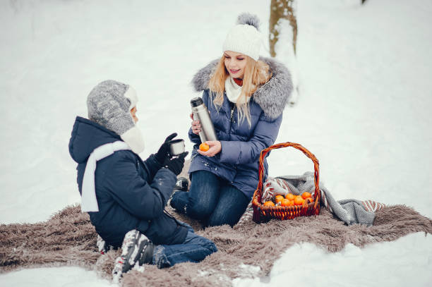 istock Mother with cute son in a winter oark 1190566816
