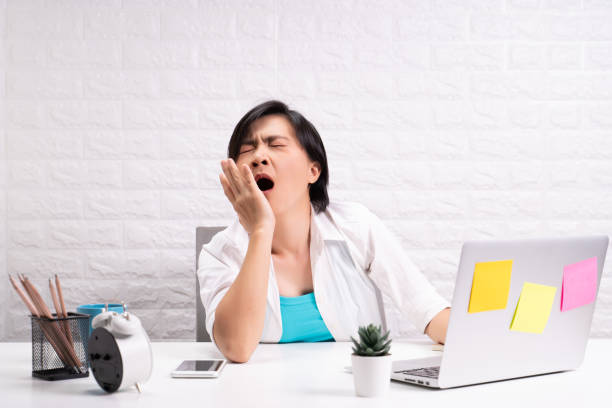 istock Bored woman at office working with a laptop 1190566937