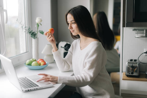 istock Serious focused young woman freelancer is working on laptop sitting 1190567027