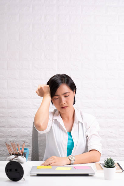 istock Woman has headache at office 1190567055