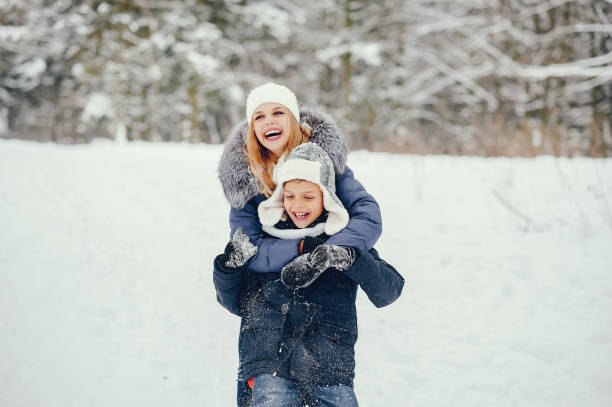 istock Mother with cute son in a winter oark 1190567140