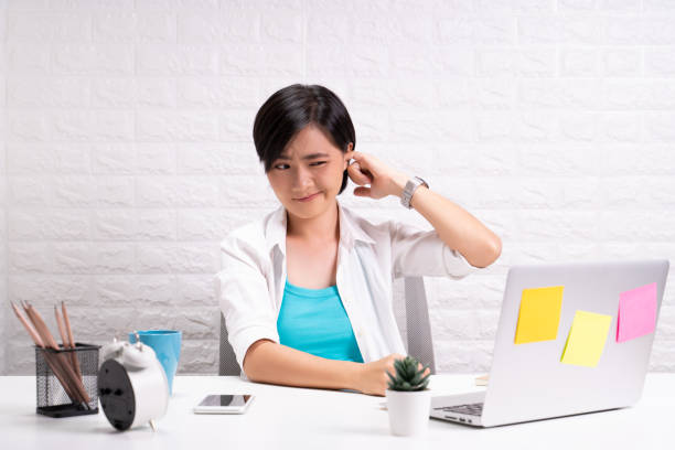 istock Woman putting a finger into her ear 1190567220