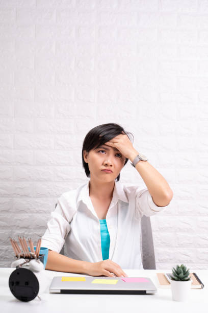 istock Woman has headache at office 1190567264