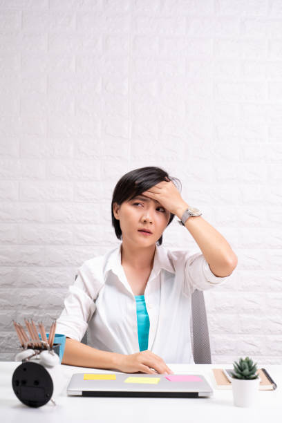 istock Woman has headache at office 1190567930