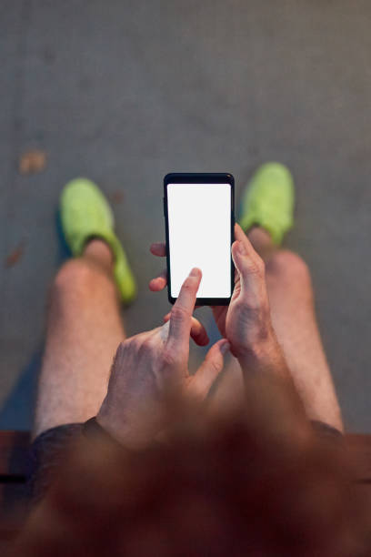 istock Man using cellphone in urban park at night. 1190568299