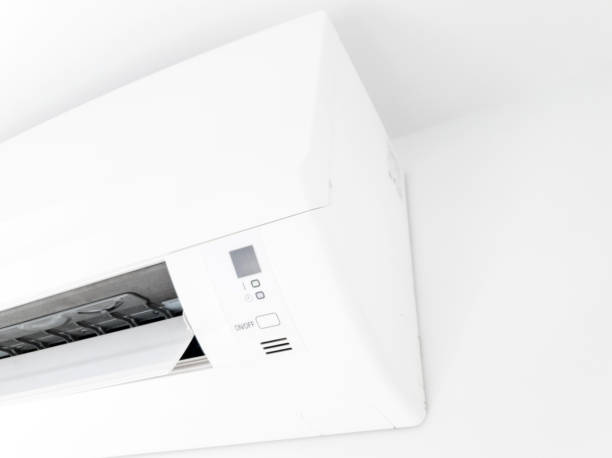 istock Modern air condition unit on a white wall inside the living room. 1190568621