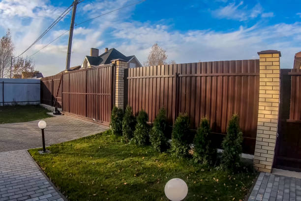 istock Fence and gate made of brown corrugated metal profile 1190568764