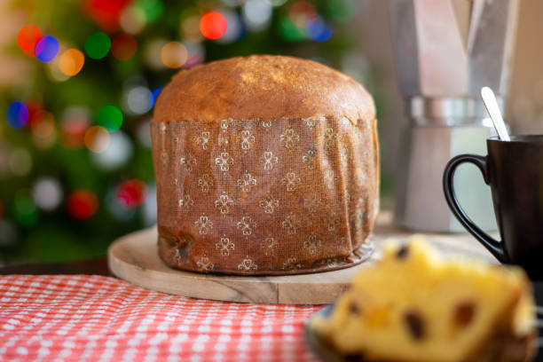 istock Christmas. Panettone with decorated Christmas background with tree and lights. Selective focus. 1190569453