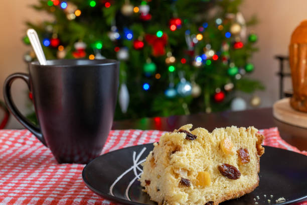istock Christmas. Panettone with decorated Christmas background with tree and lights. Selective focus. 1190569471
