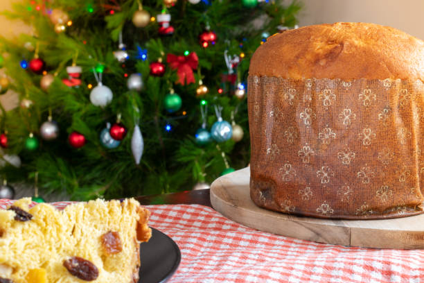 istock Christmas. Panettone with decorated Christmas background with tree and lights. Selective focus. 1190569534