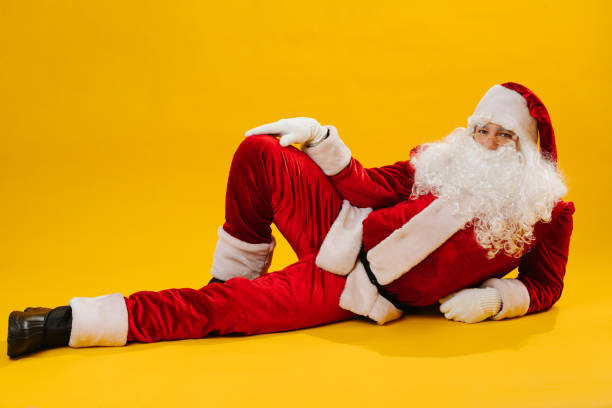 istock Cheerful Santa Claus in a funny pose, studio shot. 1190569876