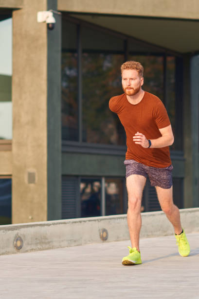istock Young man exercising / running in urban park. 1190569980
