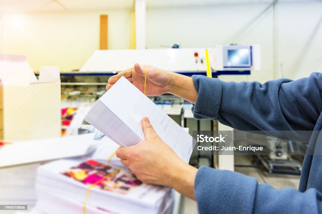 Manipulating envelopes for mailing Work with paper in a printing press Printing Plant Stock Photo