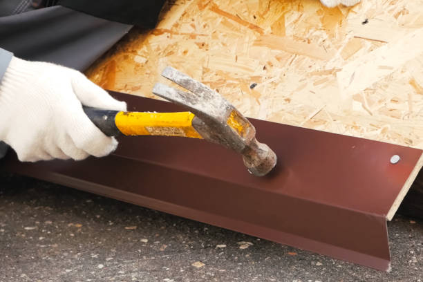 istock Nailing and hammering sheet of roofing iron. 1190571052