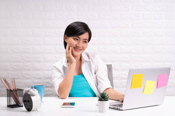 istock Happy woman sitting at home office working using computer laptop 1190571515