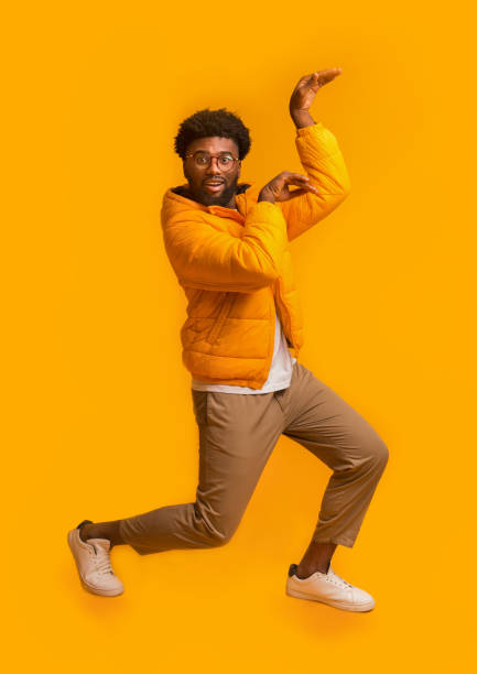 istock Winter black man dancing in egypt style on orange background 1190574023