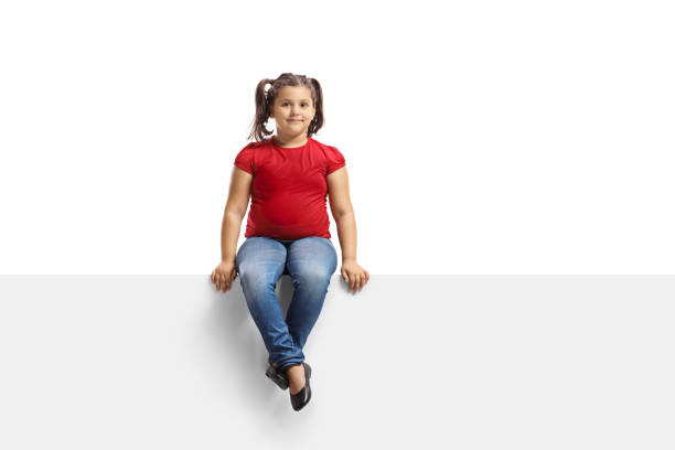 istock Smiling young girl sitting on a panel 1190574034