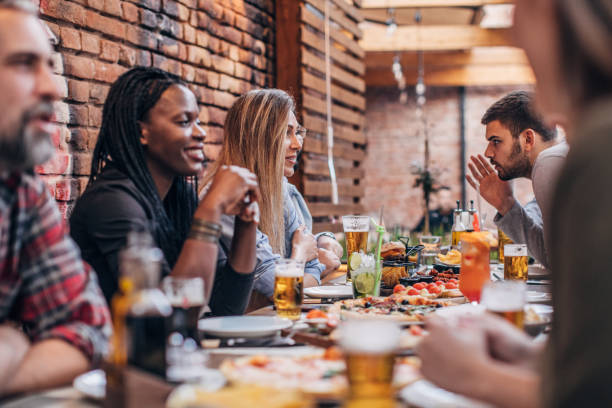 istock Friends sitting outdoors in restaurant together 1190574399