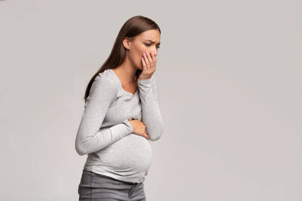 istock Pregnant Lady Feeling Sick Having Nausea Standing On Gray Background 1190576085