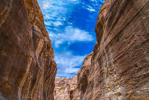 Canyon in the sandy rocks of Petra overlooking the blue sky. The ancient Nabataean city in Jordan.