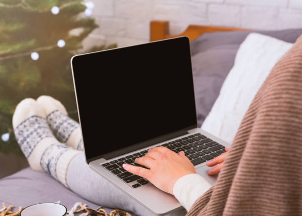 istock Modern laptop with blank screen on woman legs 1190576261