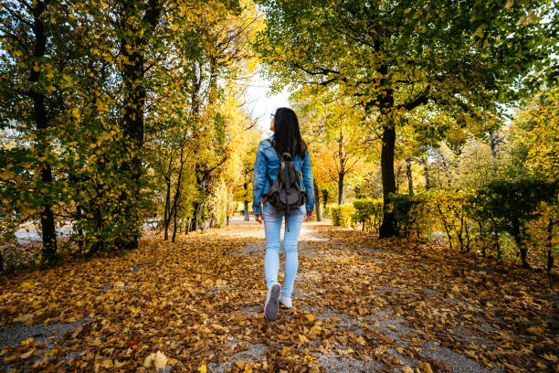 istock Woman walking in a park 1190577215