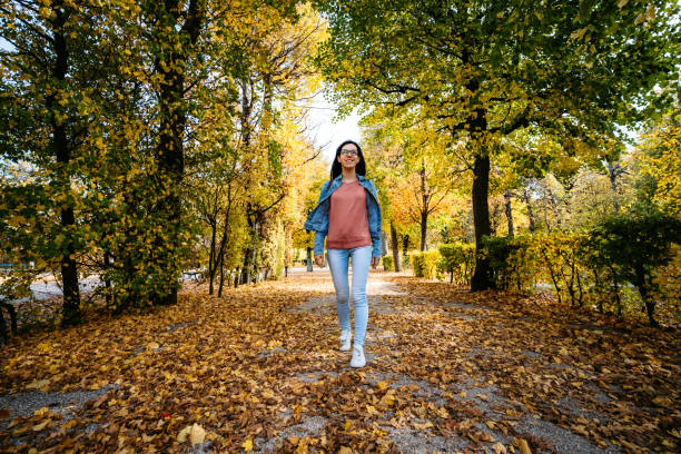 istock Woman walking in a park 1190577388