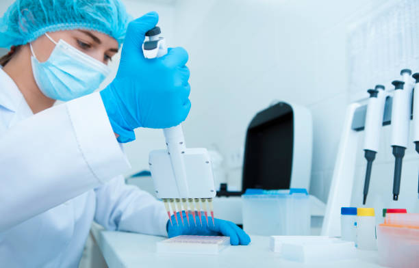 istock Woman collecting blood samples from pipette for testing 1190578360