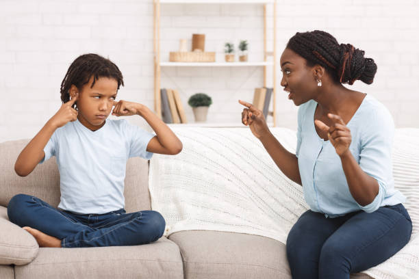 istock Afro woman lecturing her child who closing ears 1190578419