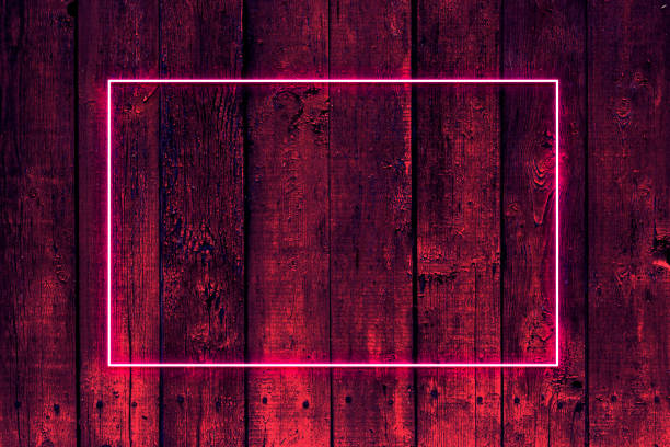 Cool creative frame on wooden background with neon fluorescent light and place for text for party, invitation.
