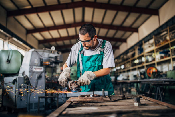 istock Man grinding in factory workshop alone 1190579792