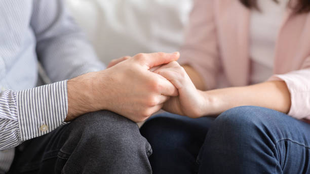 istock Man and woman holding hands, supporting each other 1190579857