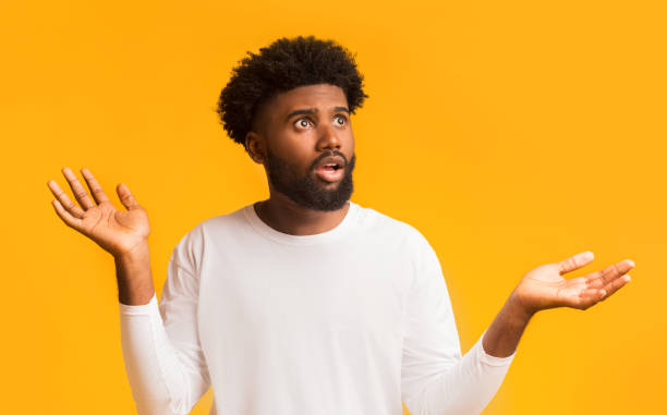 istock Excited african american man raising his hands up, looking aside 1190580043