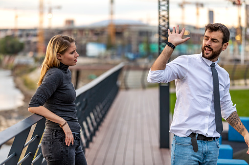 Handsome Young Man is Trying to Solve Relationship Problems with his Beautiful Girlfriend with Long Hair while Taking a Walk and Having a Harsh Conversation During Sunset Near the River.