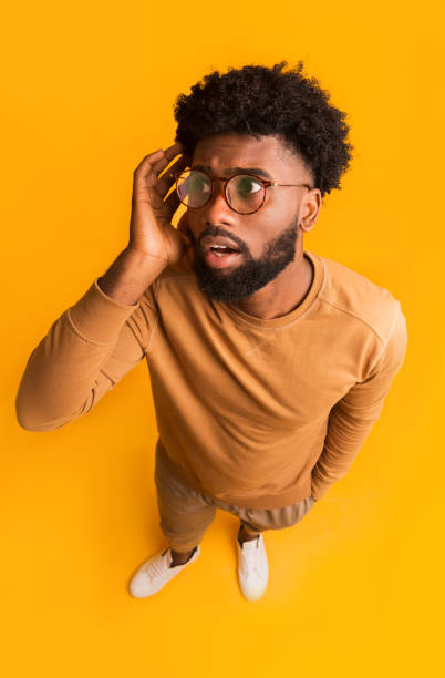 istock Top view of shocked black guy in glasses 1190580108