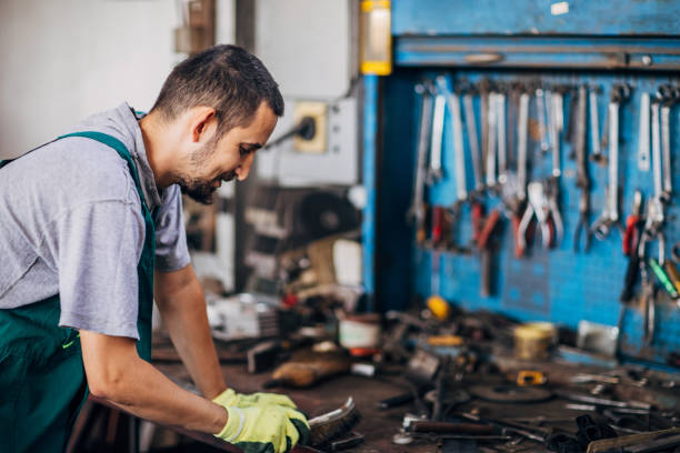 istock Man in factory workshop alone 1190580375