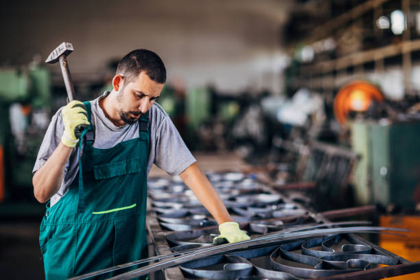 istock Young man working hard in factory workshop 1190581027