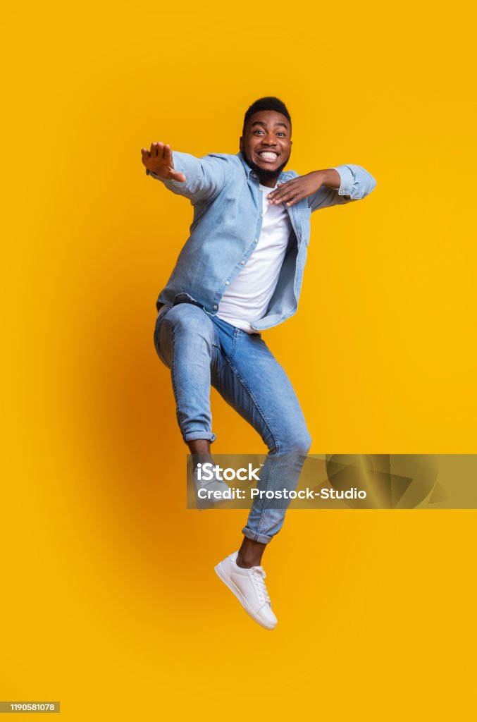 Funny Afro Guy Jumping And Making Karate Moves On Yellow Background Stock  Photo - Download Image Now - iStock