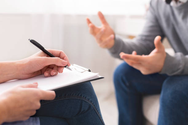 istock Psychotherapist writing notes, giving diagnosis to emotional man 1190581132