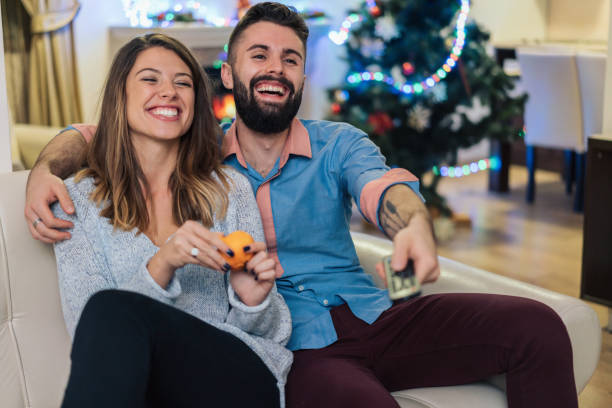 istock Happy couple watching funny television show 1190581140