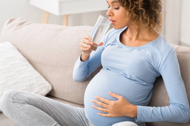 istock Pregnancy and hydration. Expectant woman drinking water 1190582247