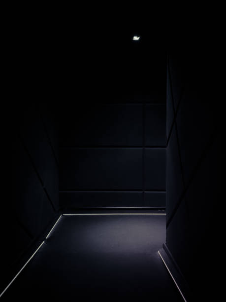 istock Corner of a dimmed empty corridor of a building 1190582599