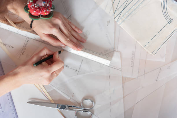 istock Flat lay woman fashion designer working on sewing patterns. 1190585930