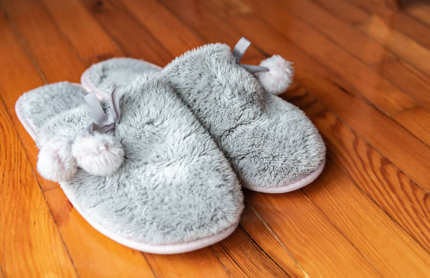 istock Cozy home slippers on wooden floor. 1190585963