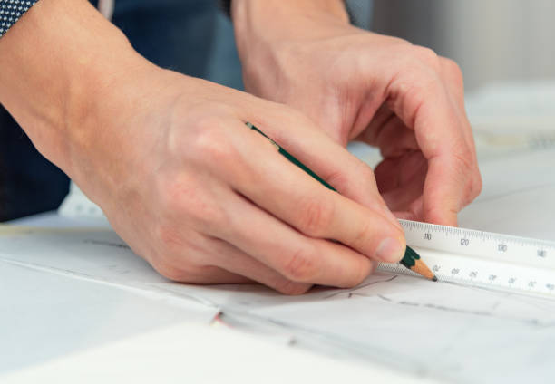 istock Professional man tailor during work with sewing patterns. Fashion design concept. 1190585968