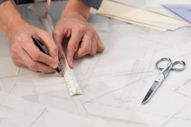 istock Professional man tailor during work with sewing patterns. Fashion design concept. 1190585982