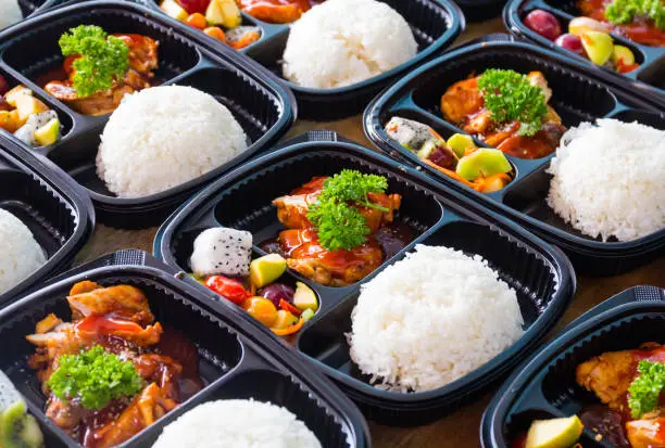 Ready to eat asian rice box, Thai food in take away plastic boxes.